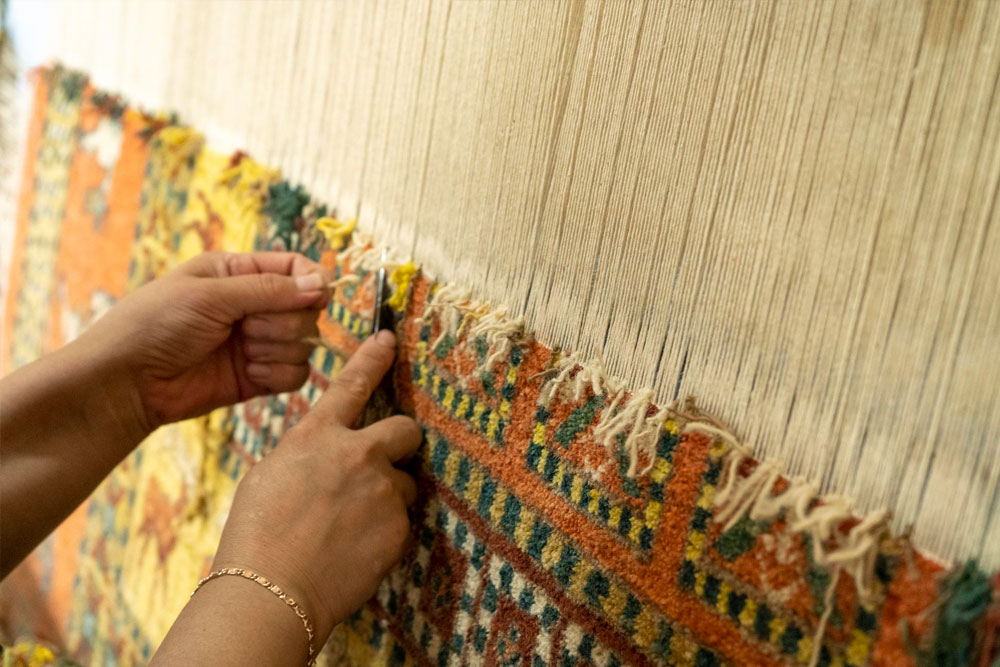 Artisan weaving on a traditional loom